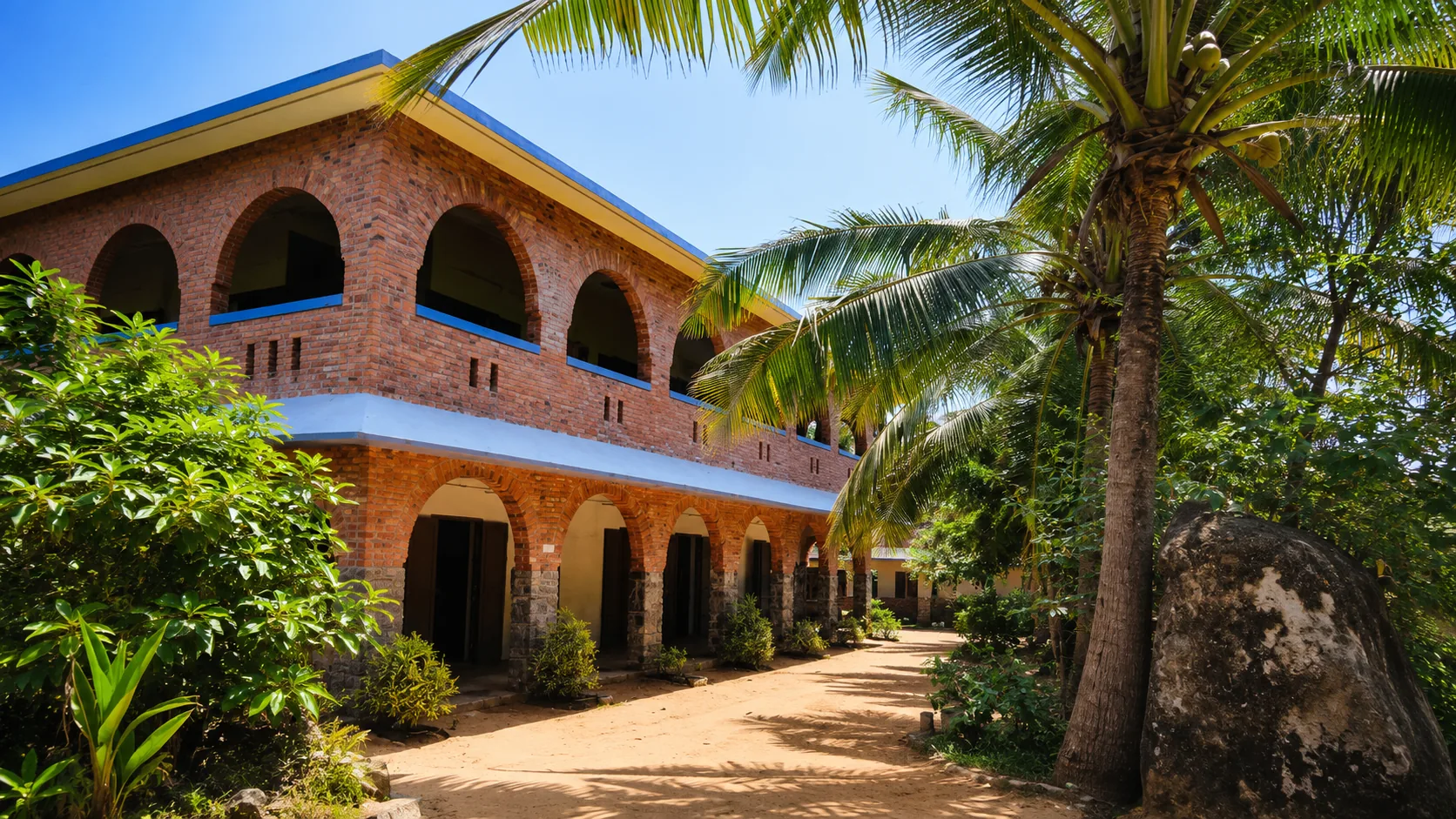 Al-Ameen Matriculation School campus surrounded by coconut trees
